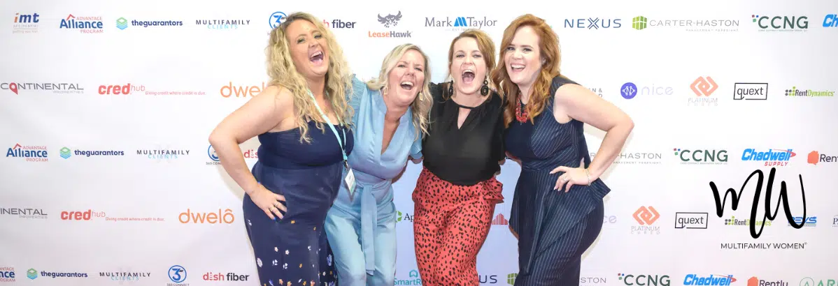 four women posing on a red carpet